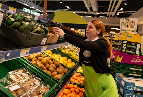 A Pingo Doce employee stocking the fruit aisle. (photo)